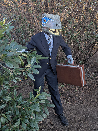 Dinosaur lawyer helping from a bush.